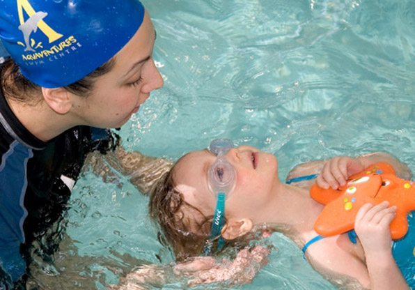 Swimming Instructor and Child with Starfish